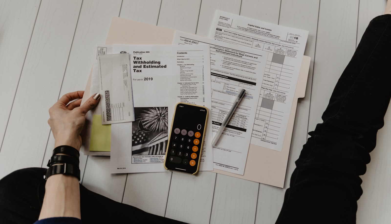 A pen resting on a printed checklist, ready to be ticked off